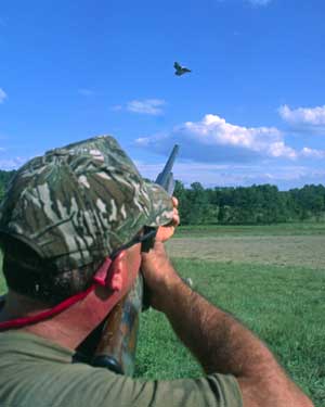 shooter aiming at flying bird