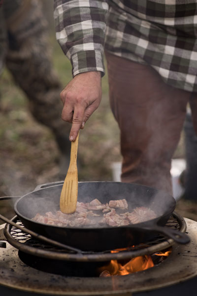 cooking bacon over fire