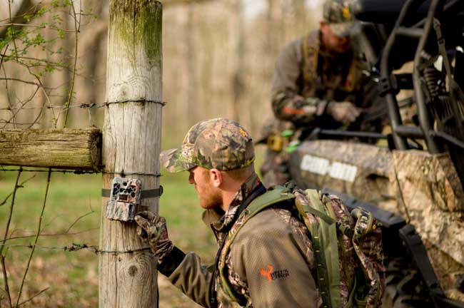 Hunter checking game camera