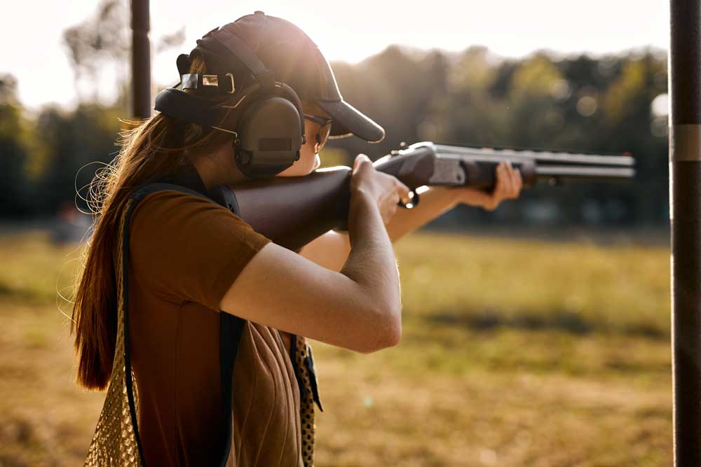 girl shooting shotgun