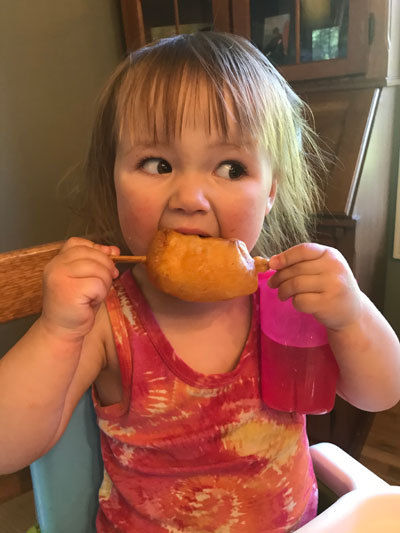 child eating homemade fish stick