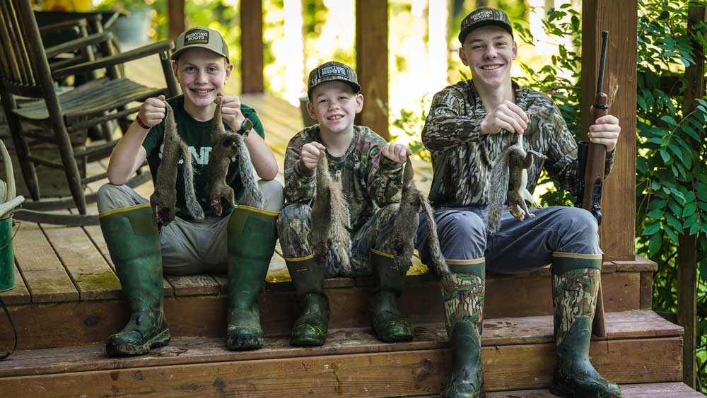 boys with squirrels on porch