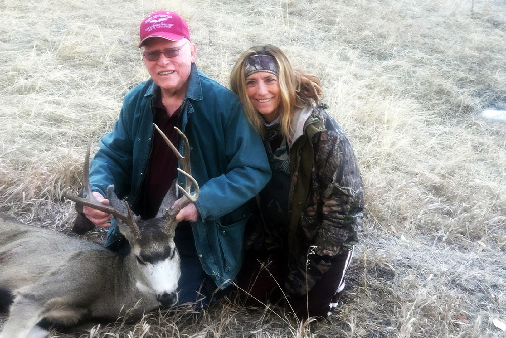 Donnelle Johnson and father with mule deer