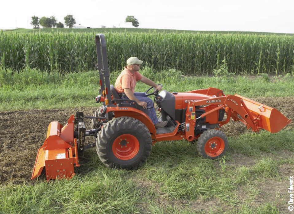 Gamekeeper using a tiller to break ground on a food plot