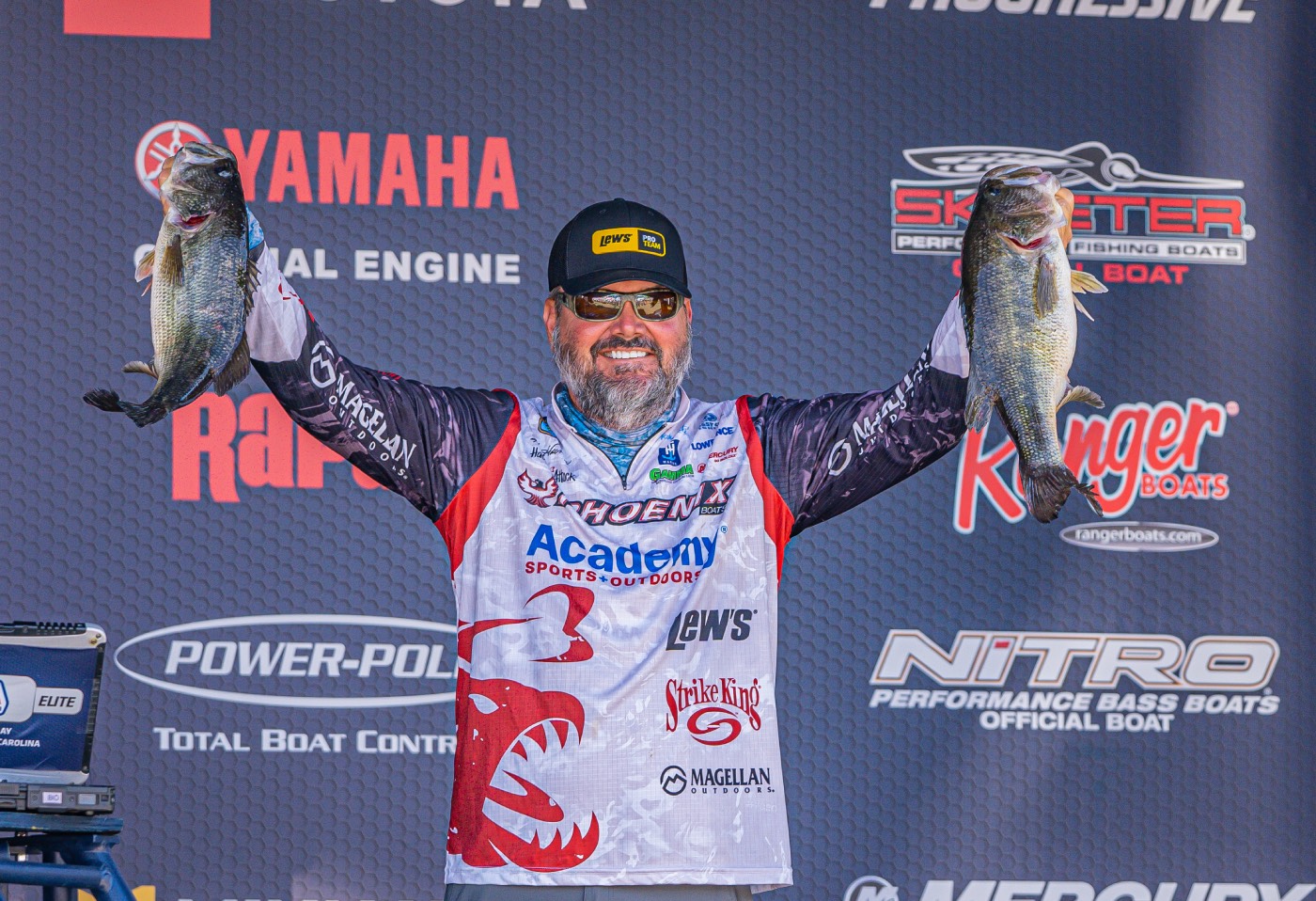 Greg Hackney holds up two bass