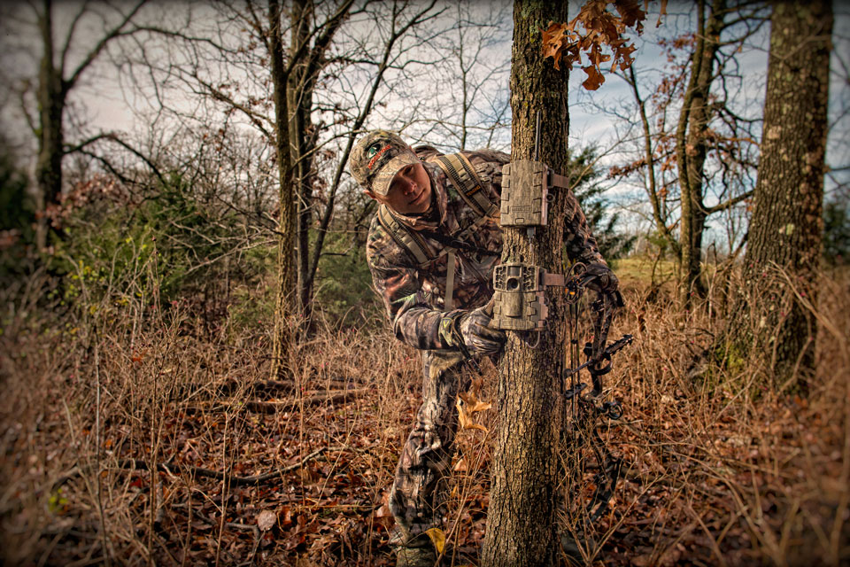 hunter checking trail camera