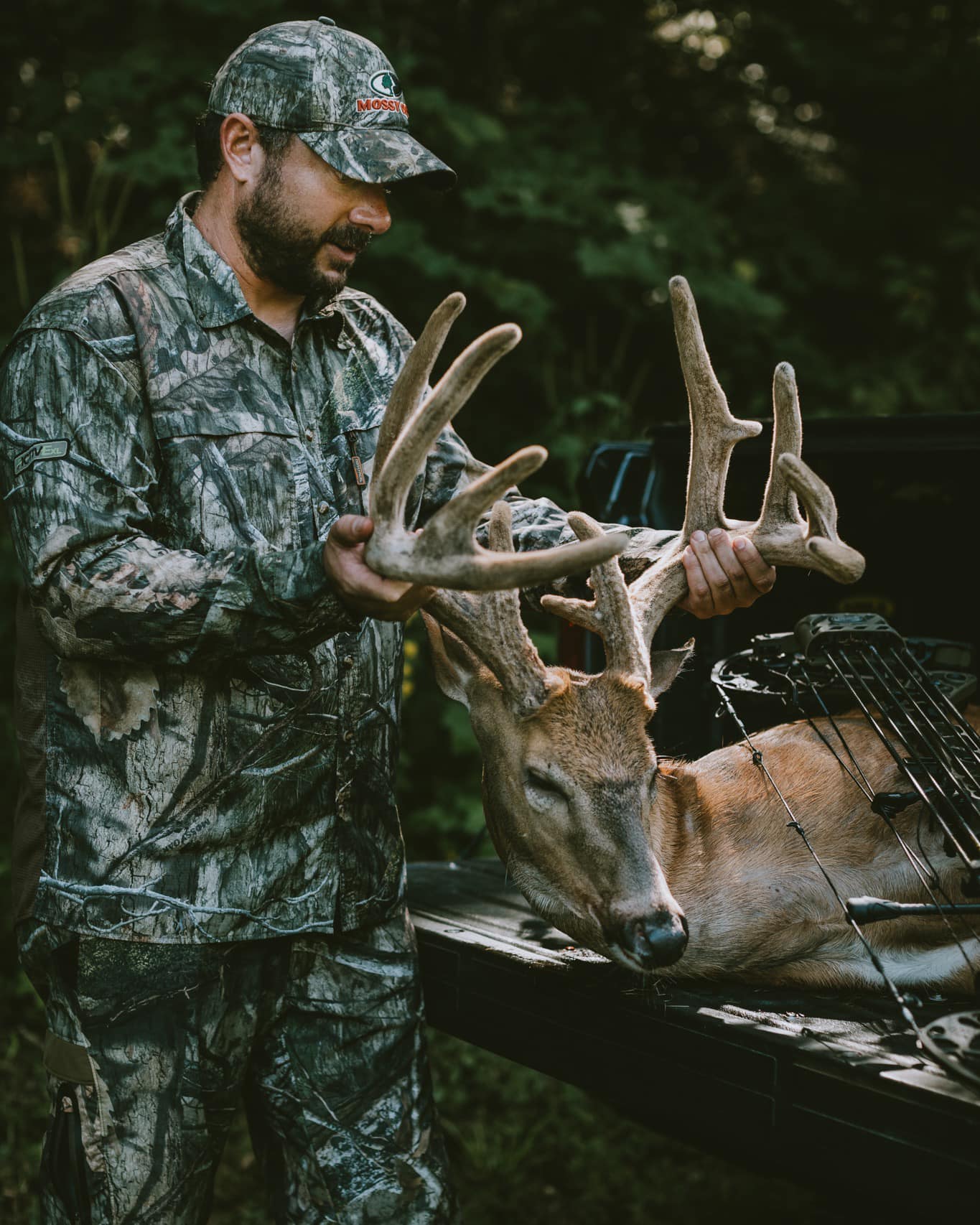 man holds up trophy velvet buck