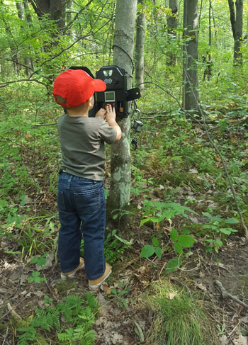 boy checking game camera