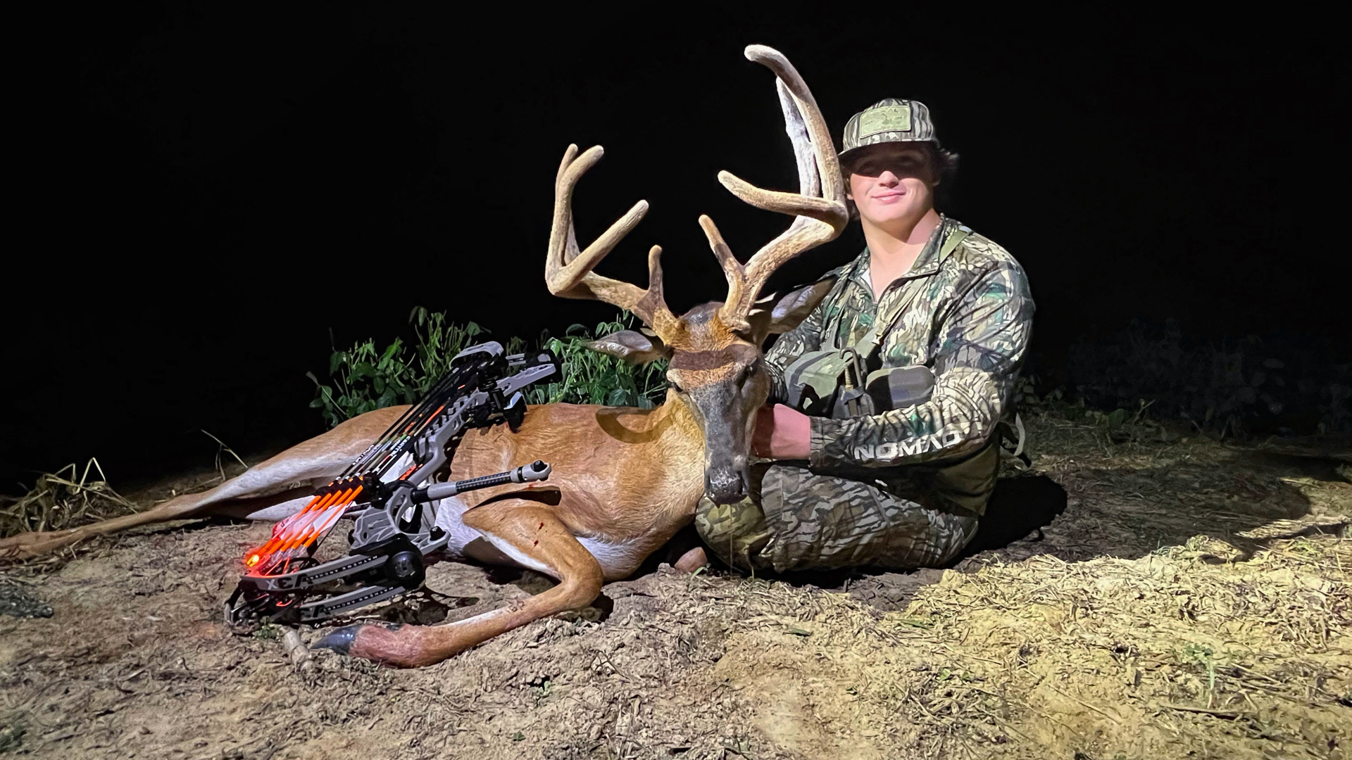 man sits with his trophy velvet buck