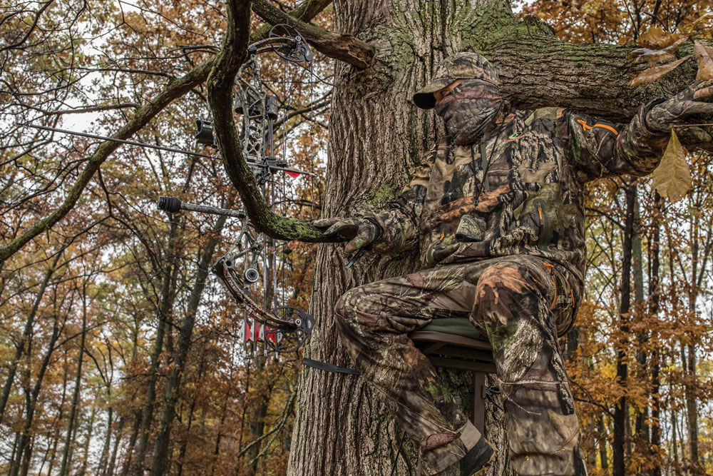 deer hunter in treestand with bow