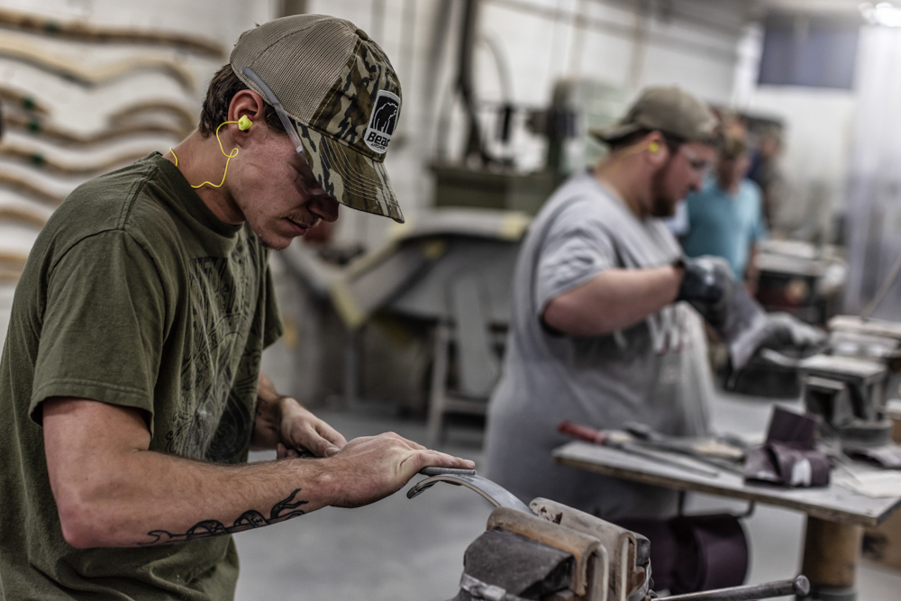 man builds a traditional bow