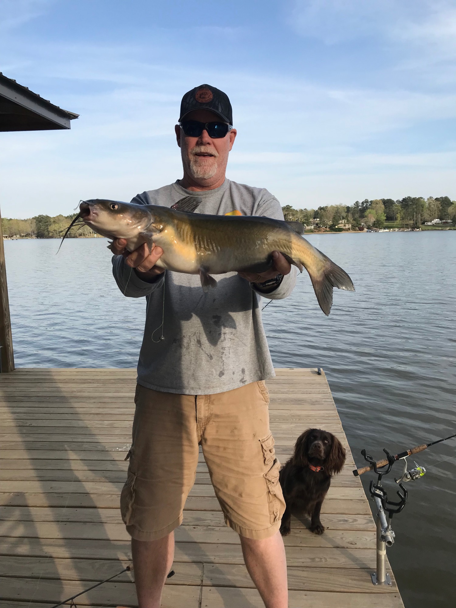 man holds catfish