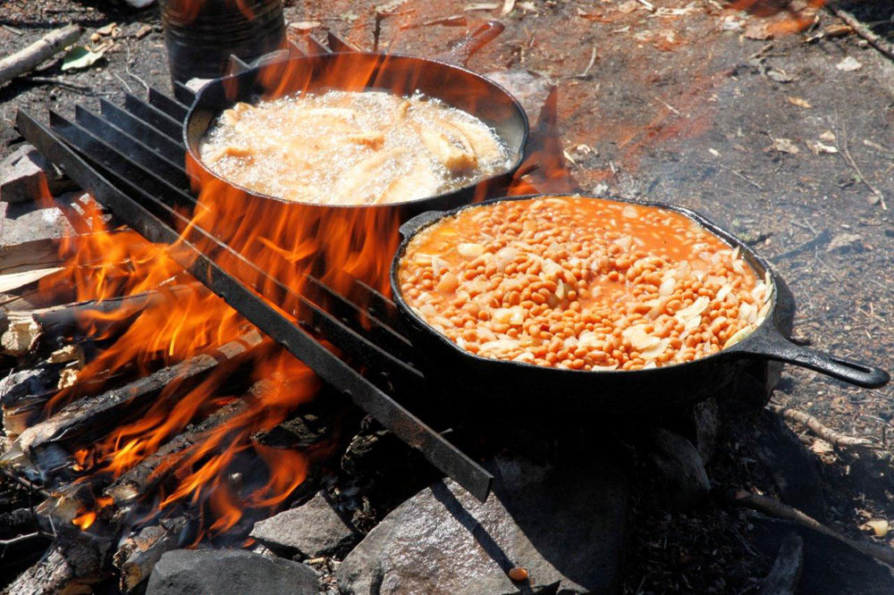 cooking with cast iron over fire