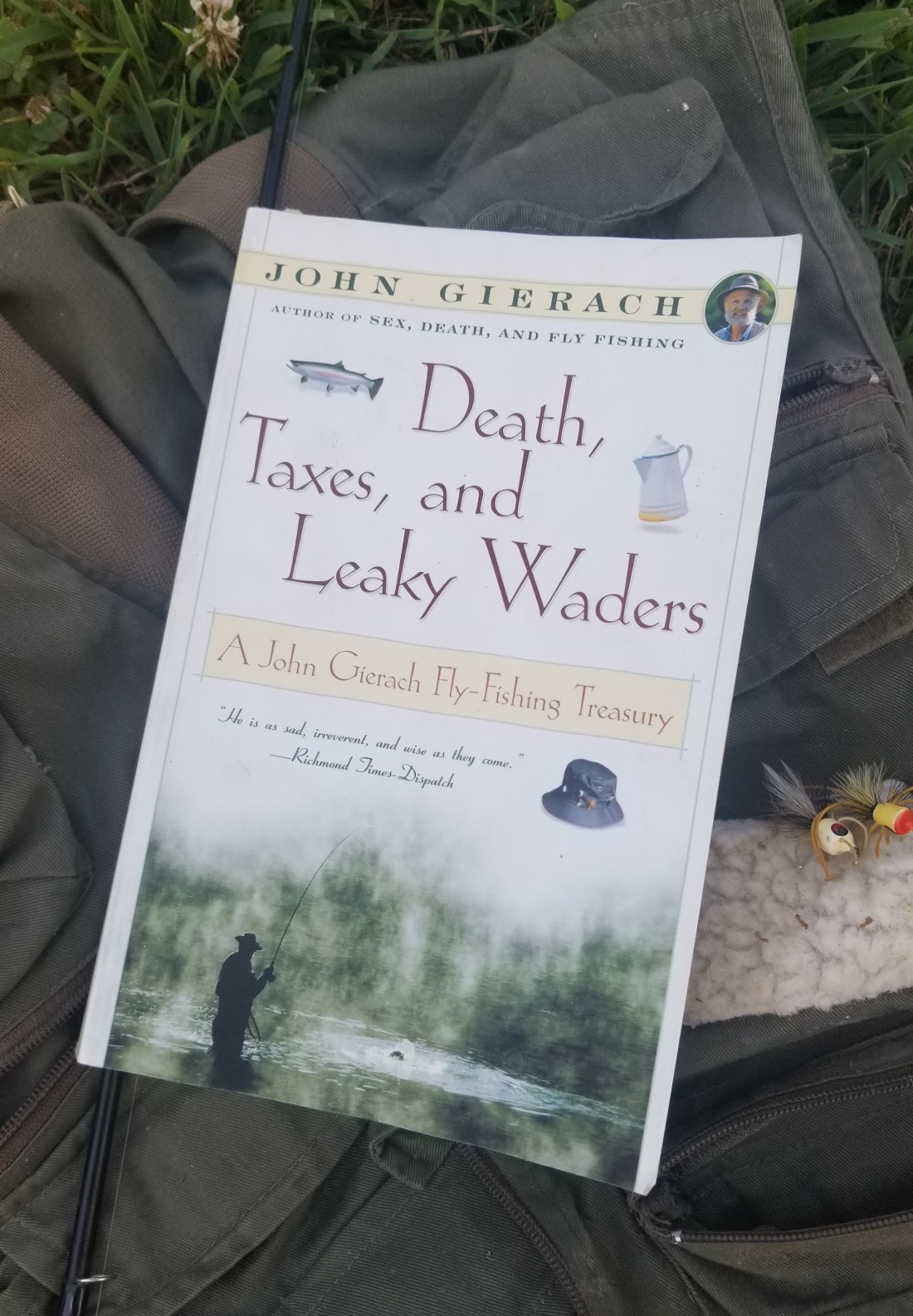 book cover next to some fly fishing flies