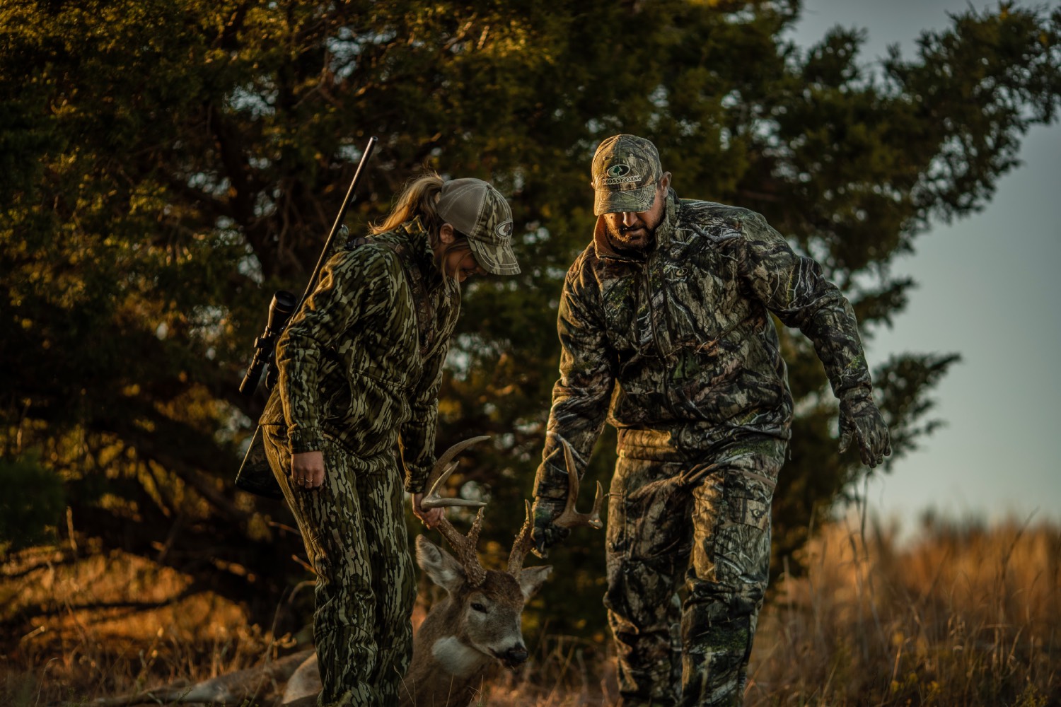 dragging deer man and woman