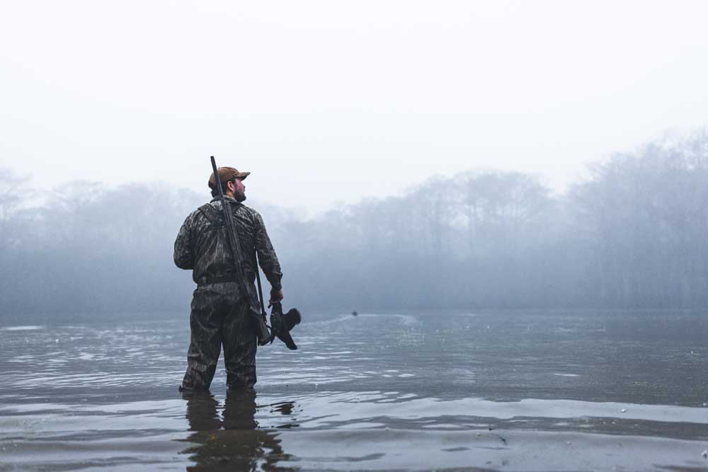 duck hunter in foggy water