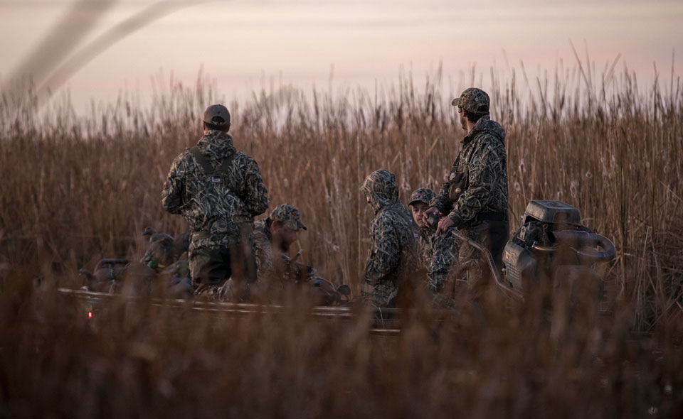 duck hunters in a boat