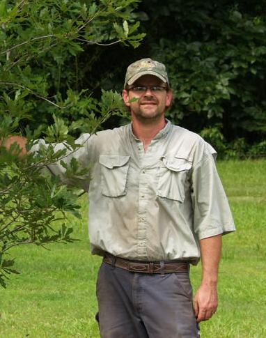 man stands with small tree