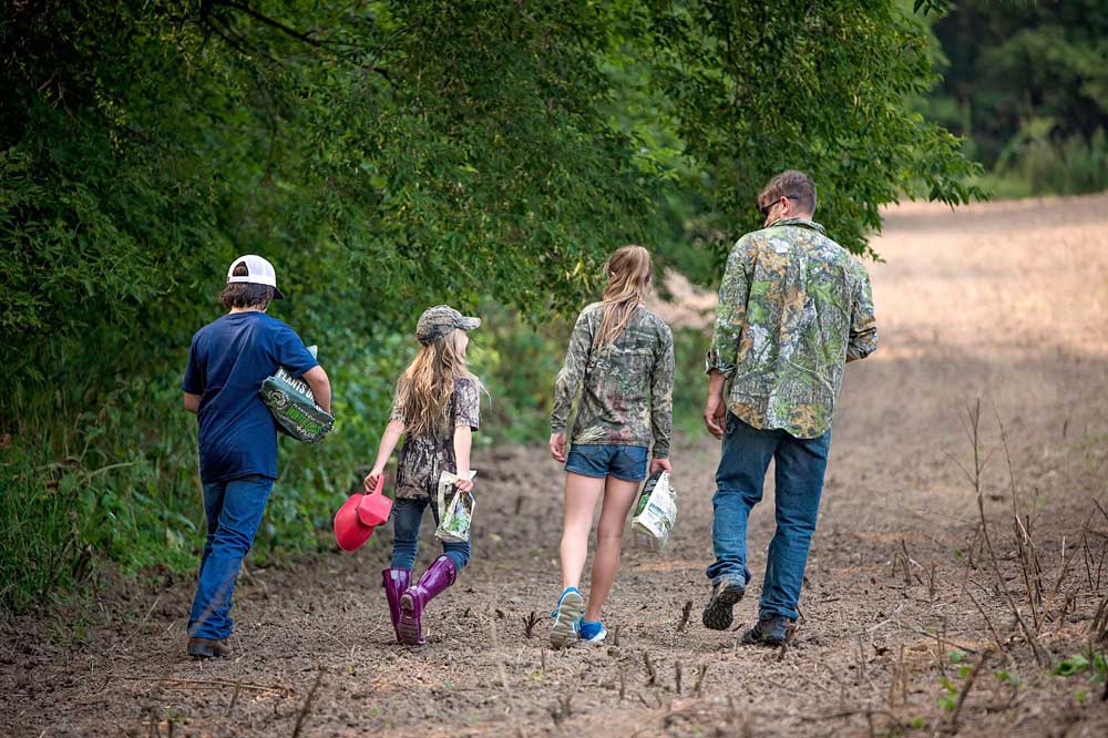 family planting food plot