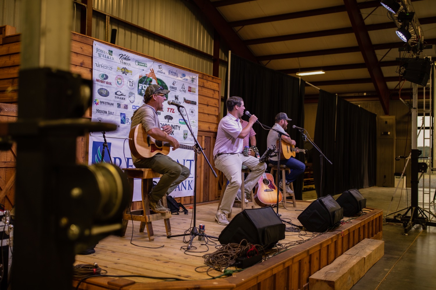 three men are on stage