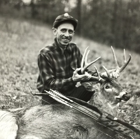 a young Fred Bear with a buck