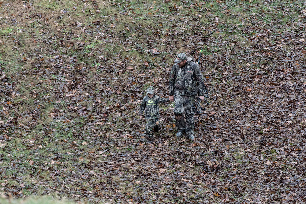 father son hiking downhill