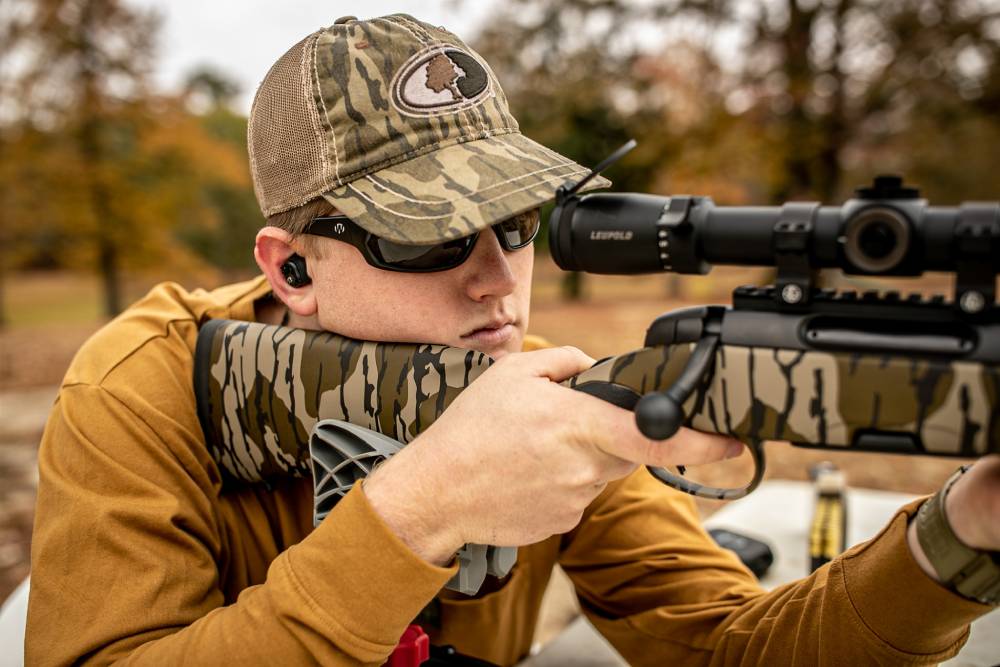 man shooting a rifle