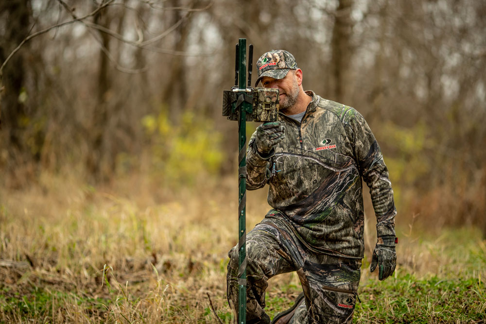 hunter checking game camera