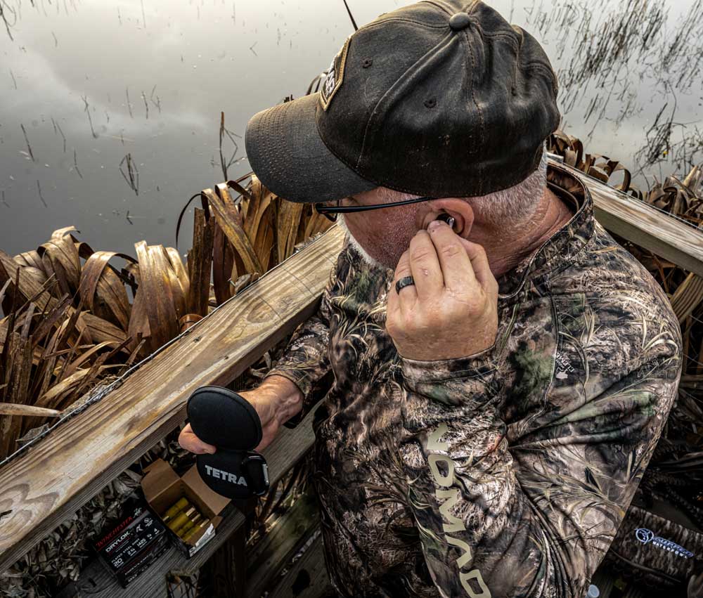 hunter inserting Tetra hearing aid