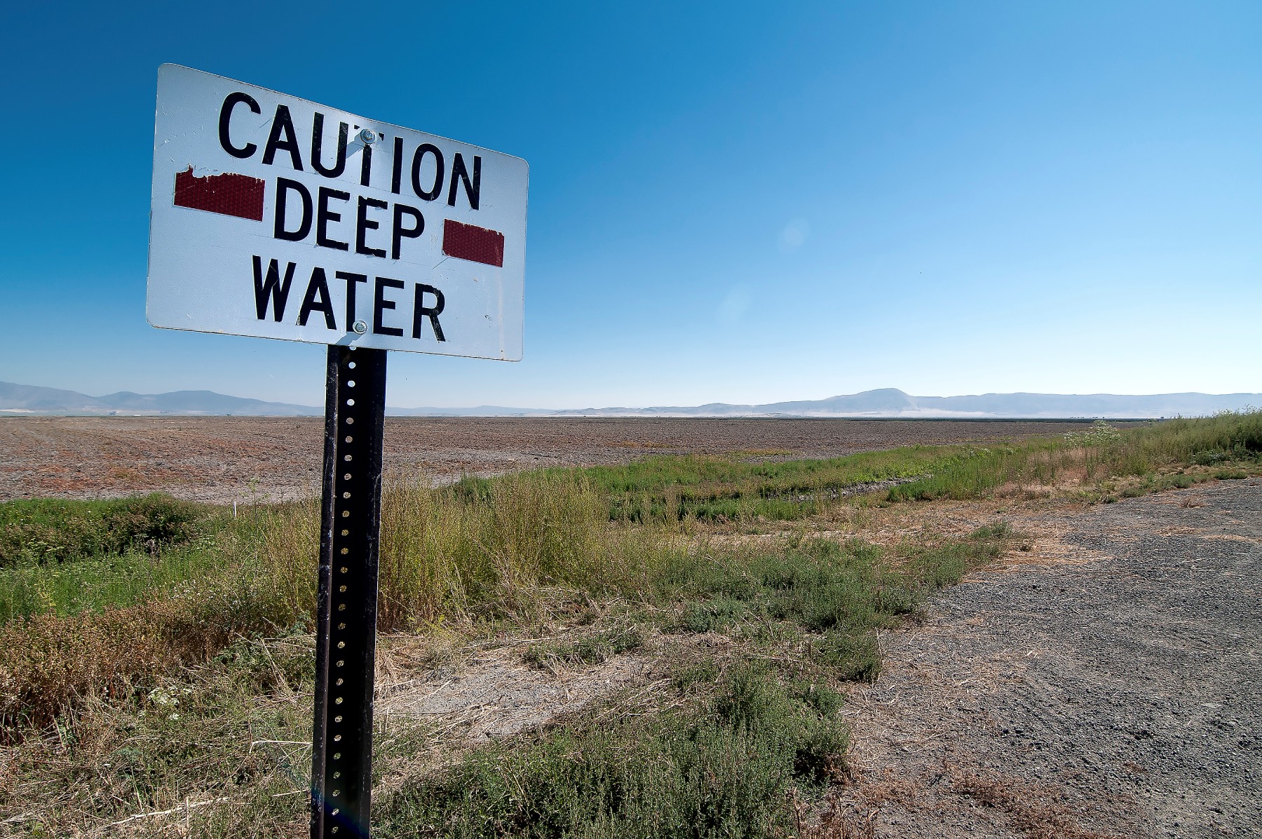 deep water sign with cracked earth