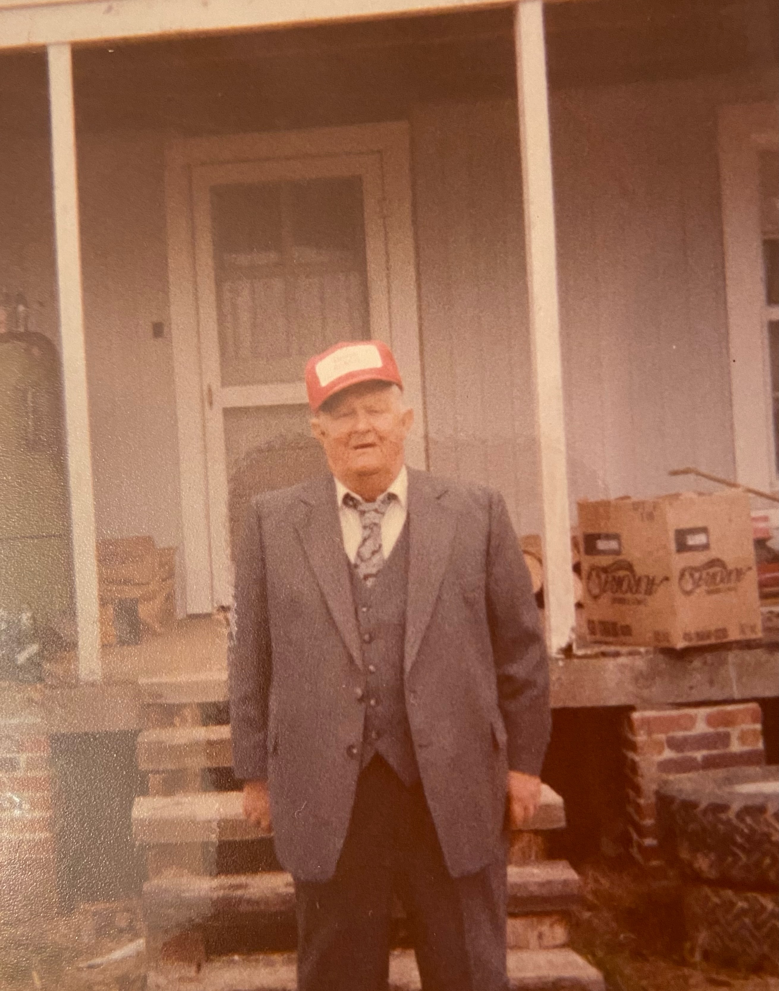 old photo of an older man standing in a suit