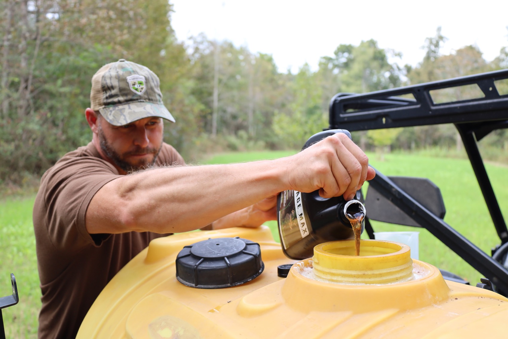 pouring liquid fertilizer