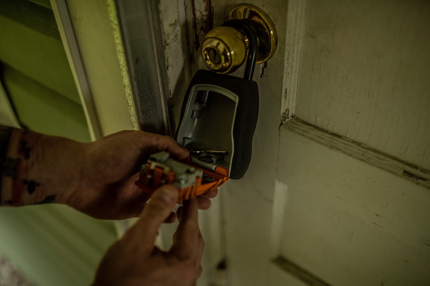 a man locking a door with a masterlock