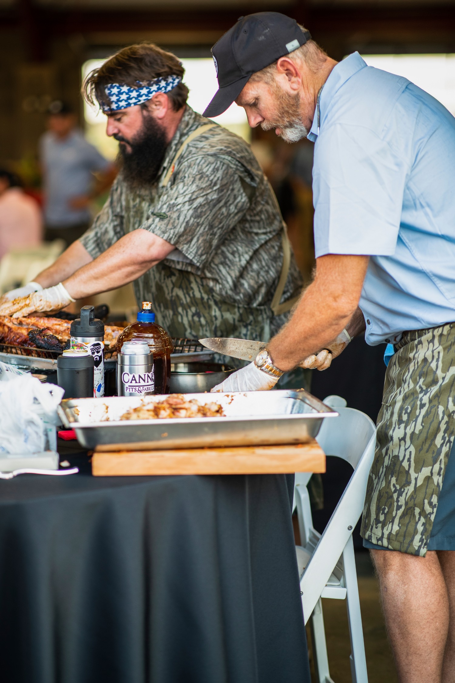 two chefs wear camo aprons