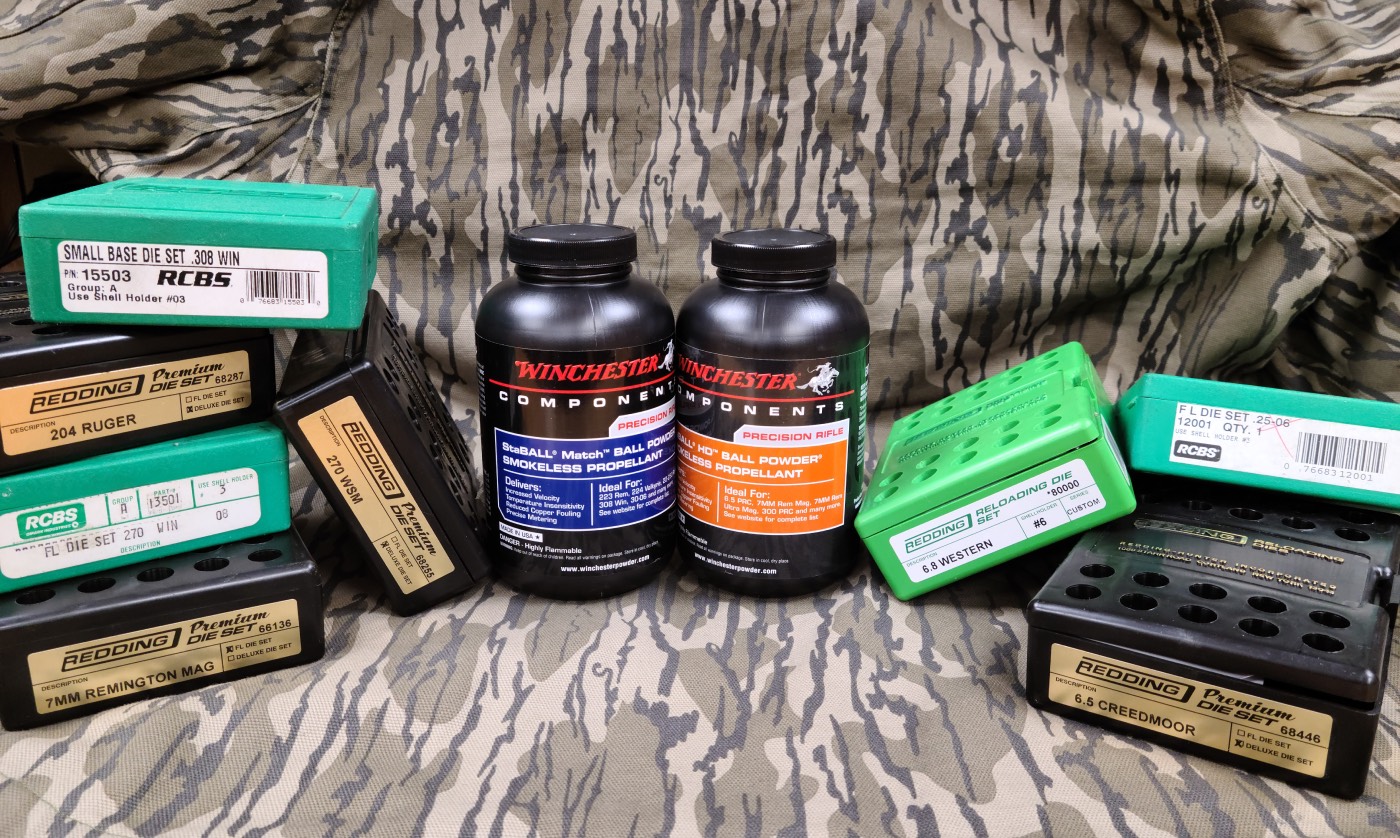 smokeless powders lined up on camo background