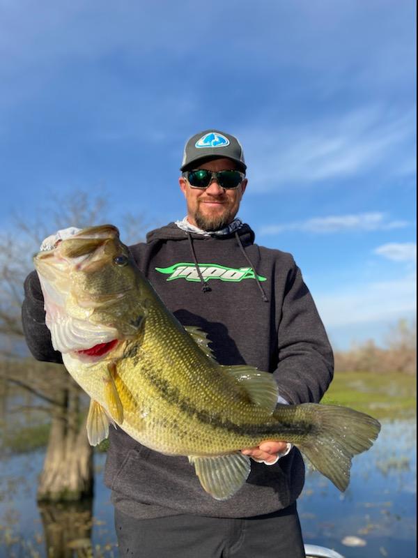 man holding giant bass