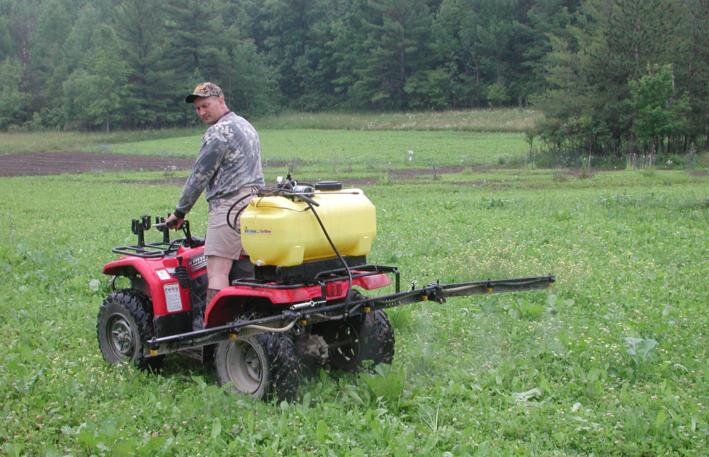 spraying a clover field with ATV