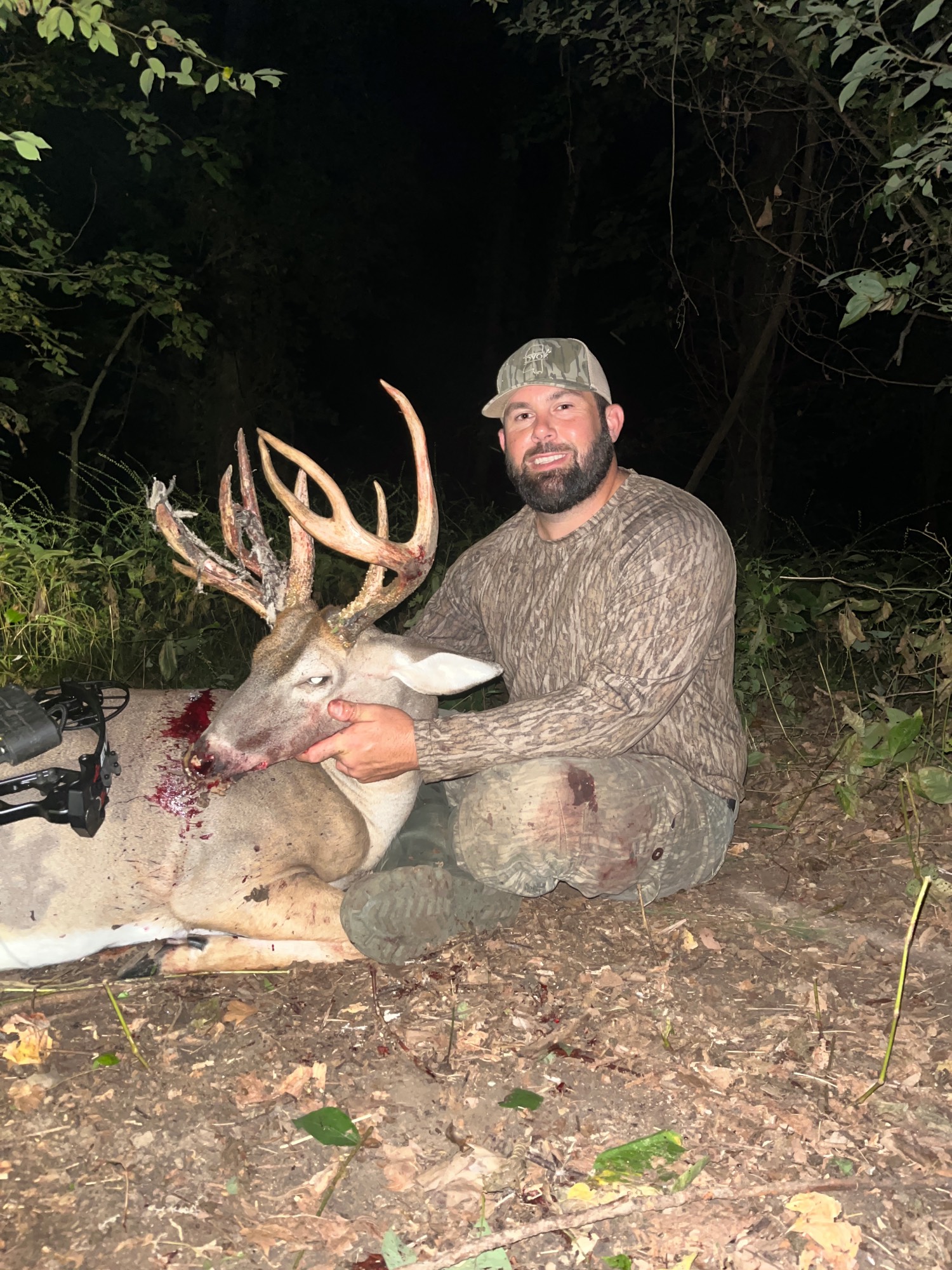 man poses with velvet buck