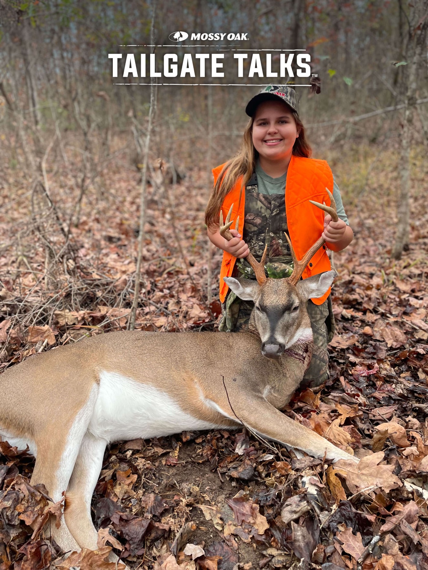 young girl holds up medium size buck with dark face
