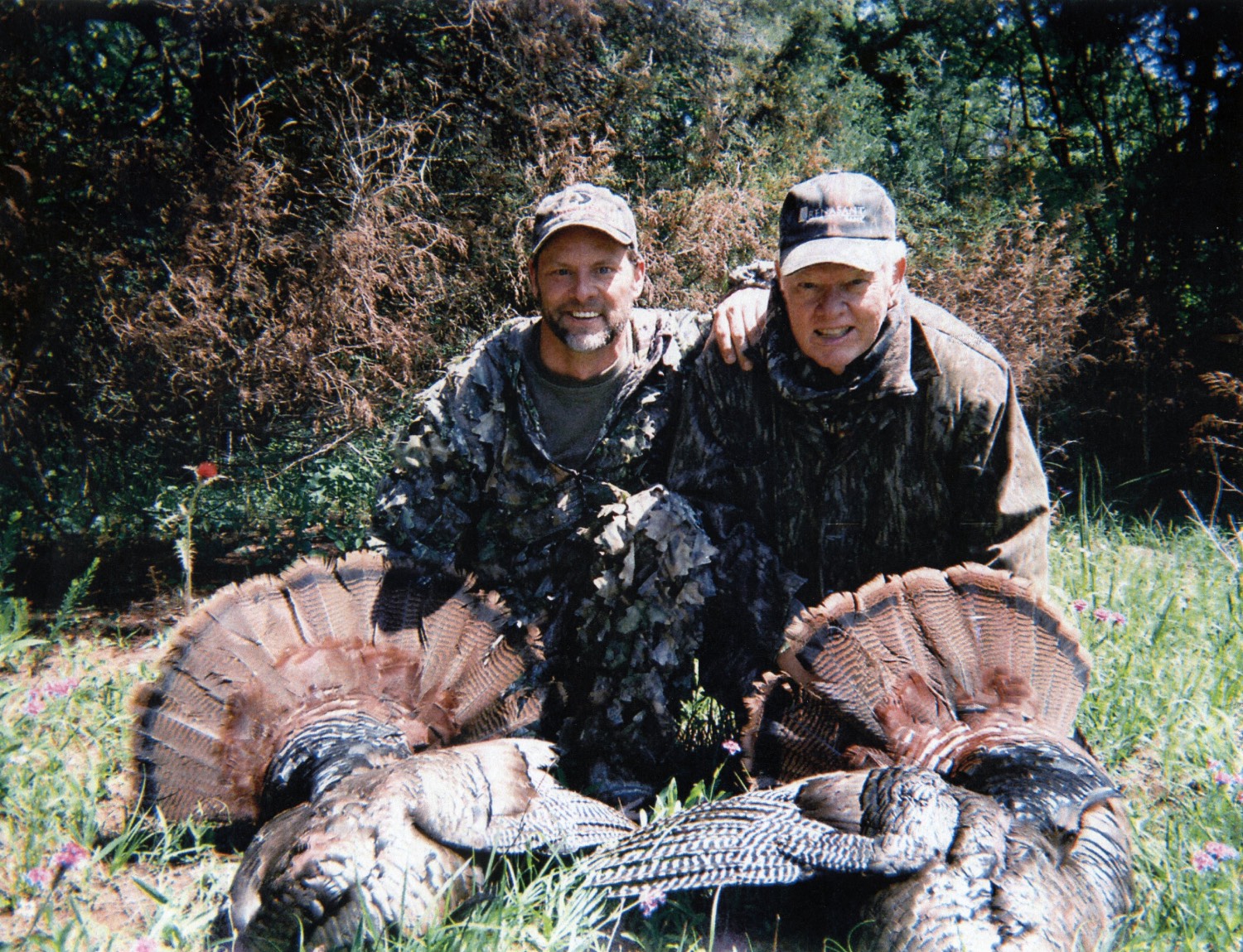 Toxey and Fox Haas pose with two turkeys
