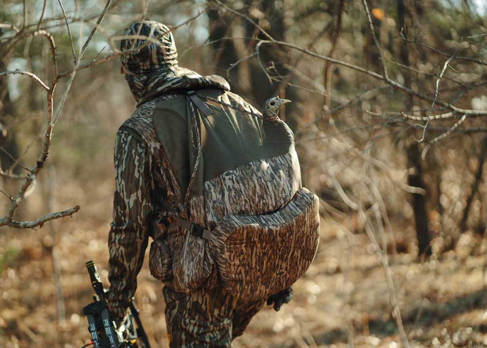 hunter with turkey decoy in vest