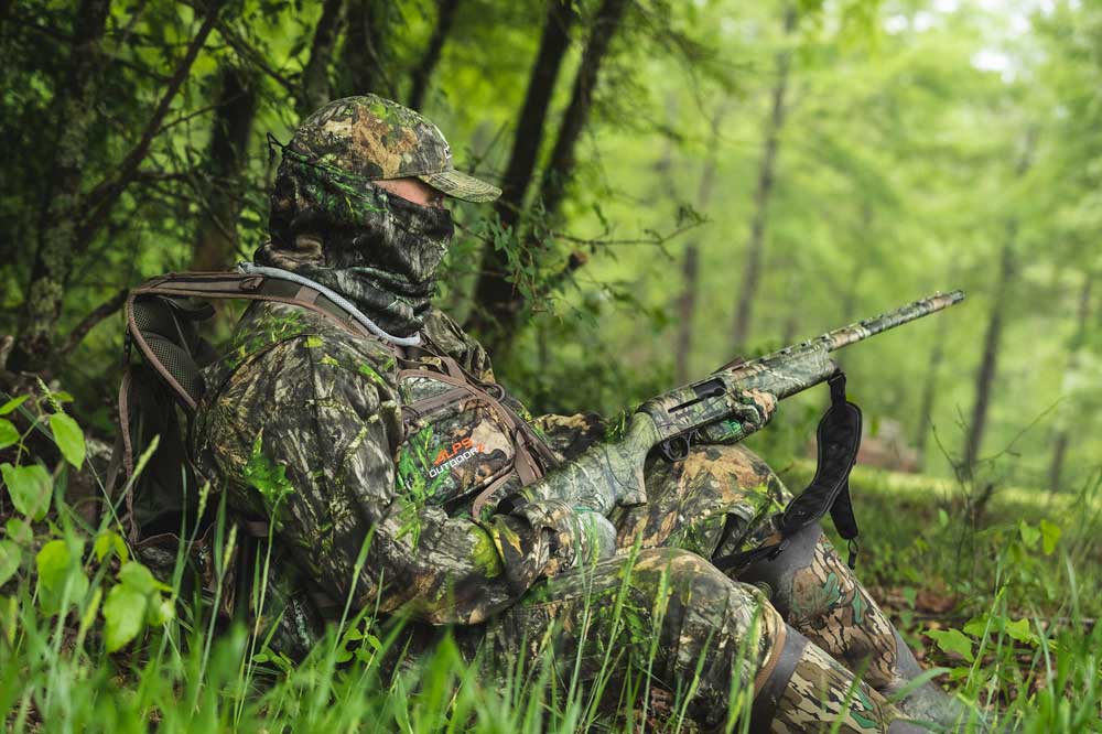 turkey hunter set up by tree