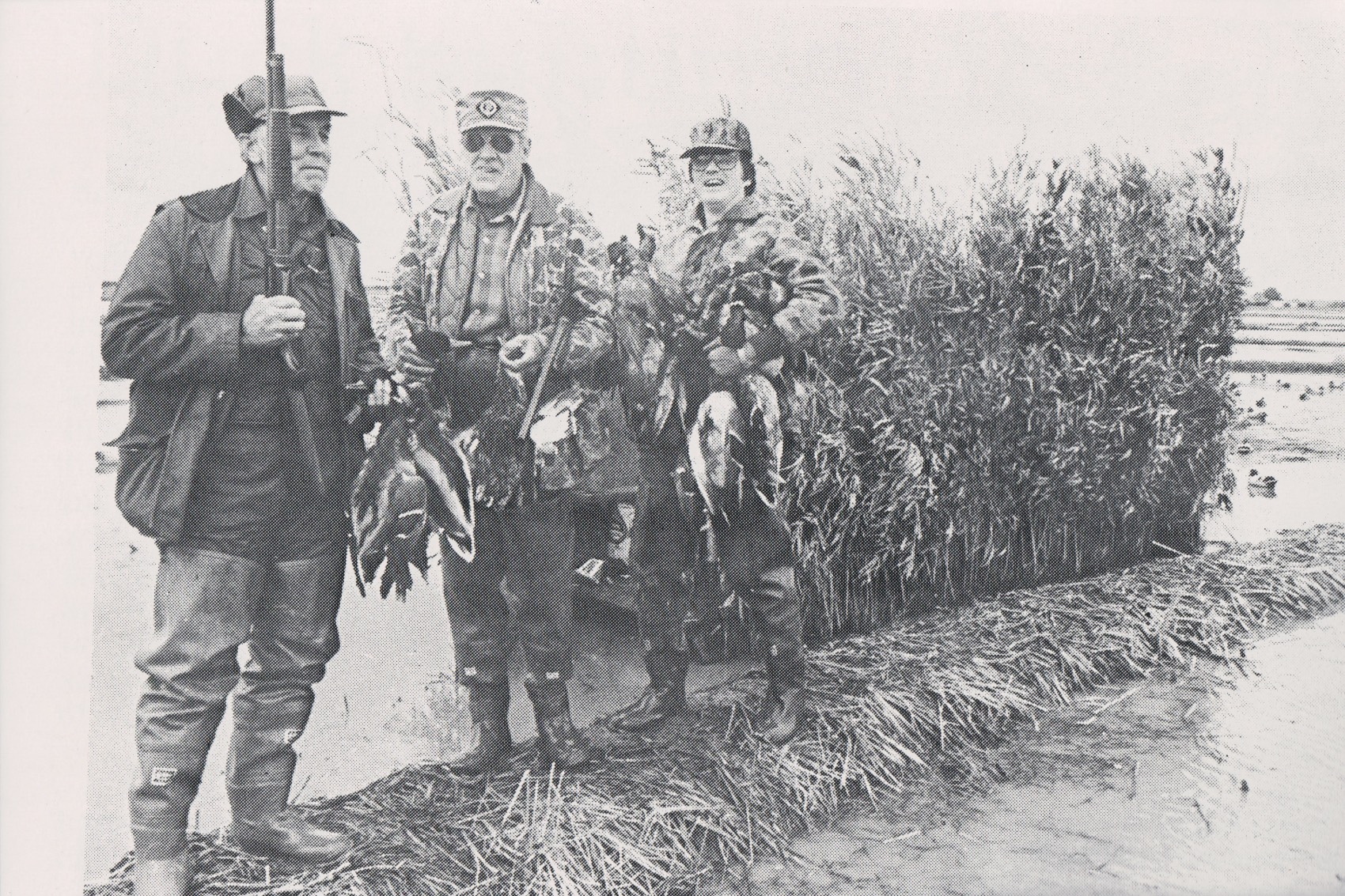 black and white photo of men in a blind