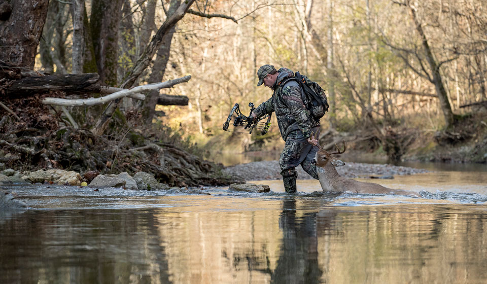 hunter walking through water