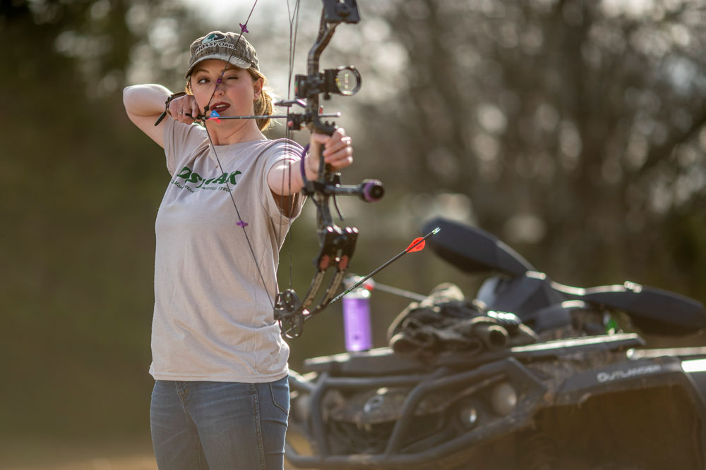 woman aiming bow