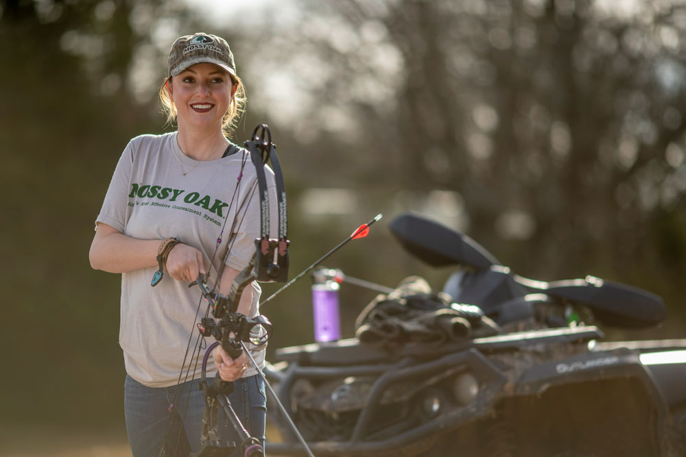 woman practicing archery with bow